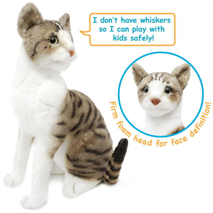 A plush toy resembling an American Shorthair cat with a mackerel tabby coat, featuring a realistic design with stripes, seated upright, with a focus on its face and detailed features.