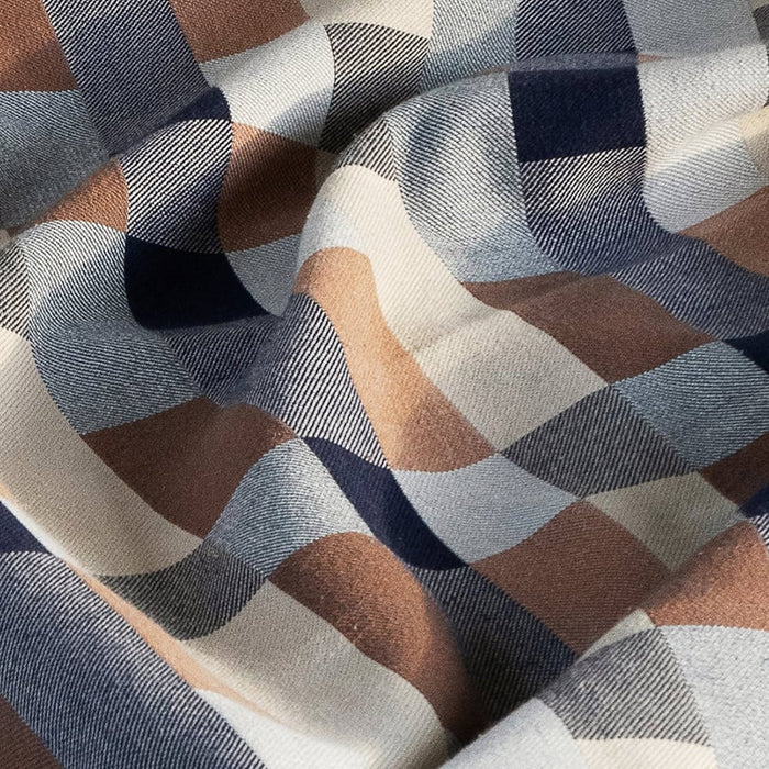 Blanket in a checkerboard pattern of grey, tan and brown.