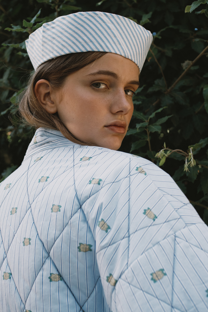 Tiny Big Sister striped jacket with delicate mini floral detail, softly padded and fully lined. A fresh, stylish layer for spring. Shop at Dotique.