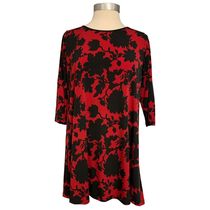A red and black floral patterned top with 3/4 length sleeves, displayed on a mannequin.
