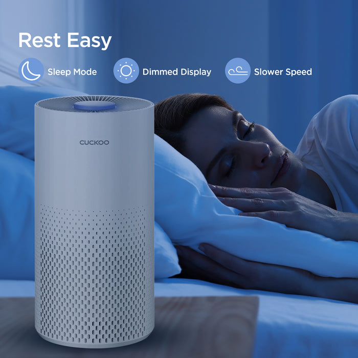 CUCKOO air purifier in a bedroom, highlighting 'Rest Easy' features: Sleep Mode, Dimmed Display, and Slower Speed. (CAC-I0510FW)