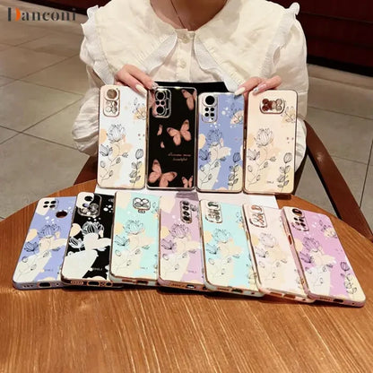 a woman holding a phone case with cartoon characters on it