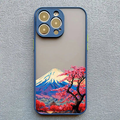 a phone case with a painting of a cherry tree and mountains