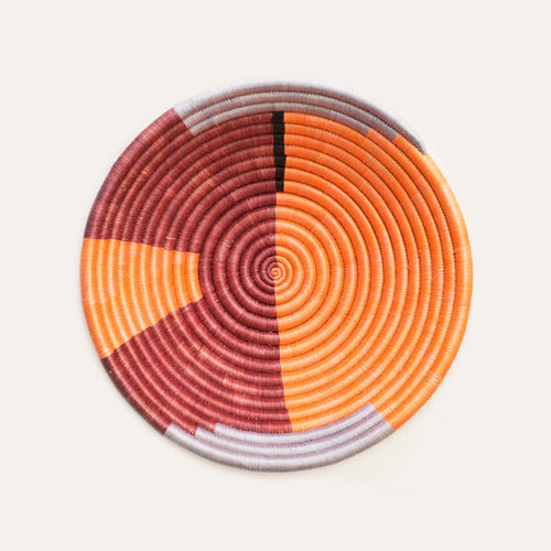 Round woven coaster with concentric circle pattern on a white background