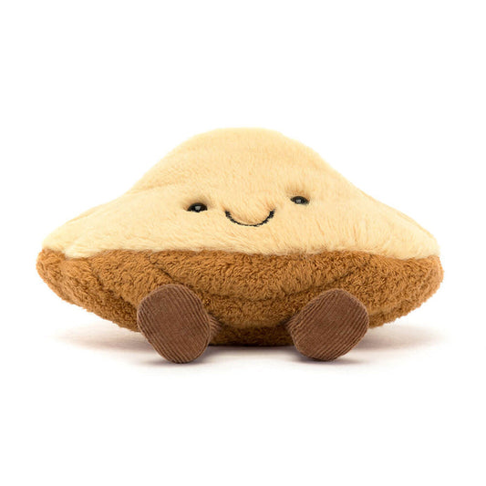 Plush toy resembling a madeleine pastry with a smiling face on a white background