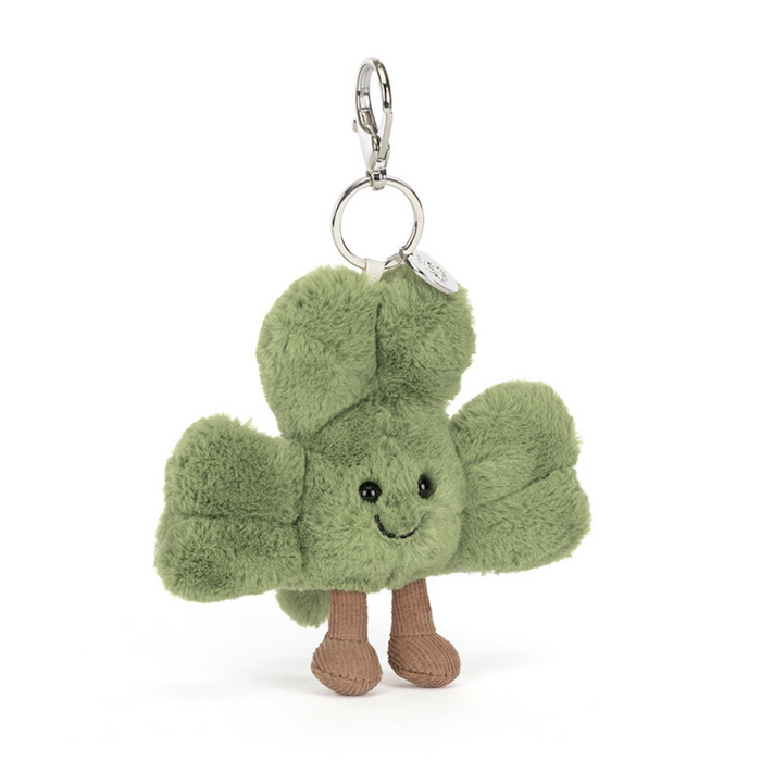 Green plush keychain with a smiling face on a white background
