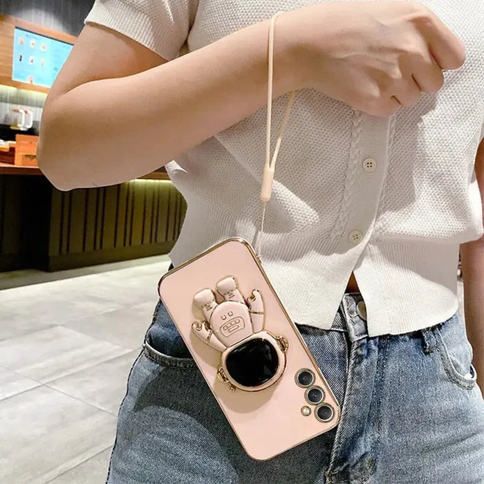 a woman holding a phone case with a camera attached to it