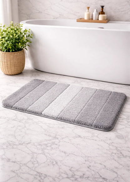 Black rectangular bath mat with light stripe panels and textured pile
