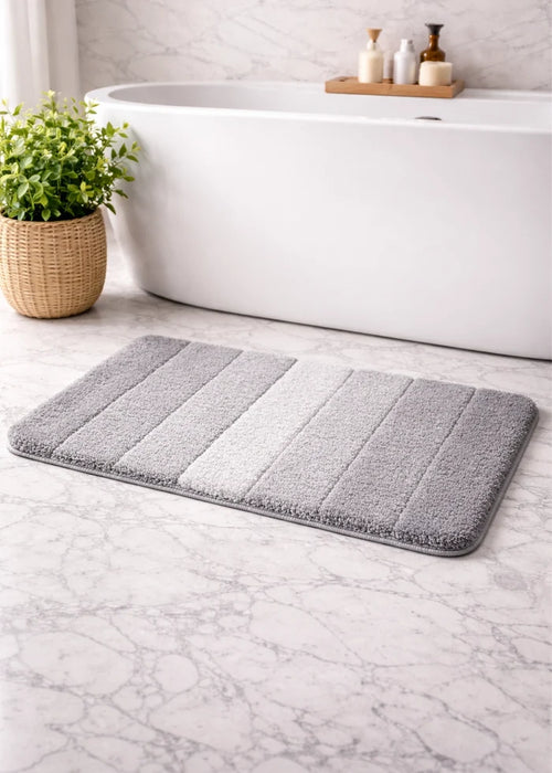 Black rectangular bath mat with light stripe panels and textured pile
