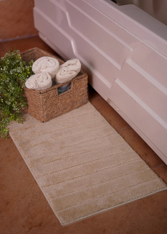 Brown bath mat rug with textured pile and horizontal stitched lines