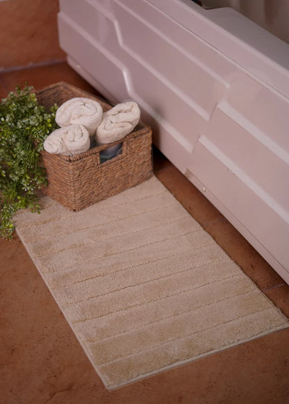 Brown bath mat rug with textured pile and horizontal stitched lines