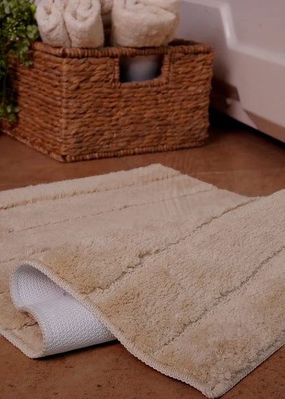 Brown bath mat rug corner detail, textured pile and rolled edge