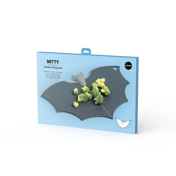 Bat-shaped cutting board with broccoli in packaging on a white background