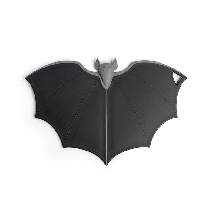 Black bat-shaped cutting board on a white background