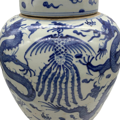 Blue and white lidded ceramic ginger jar with dragon and phoenix motif.