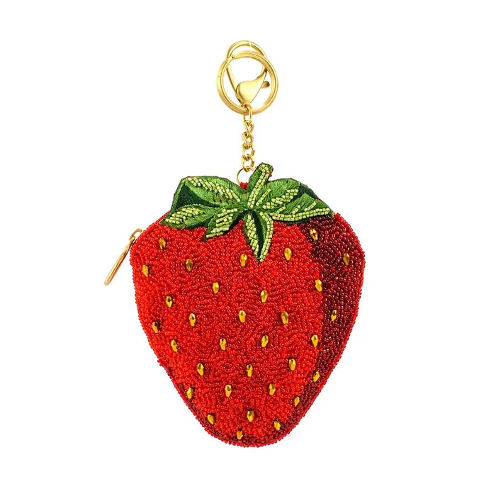 Red beaded strawberry coin purse with gold chain on a white background.