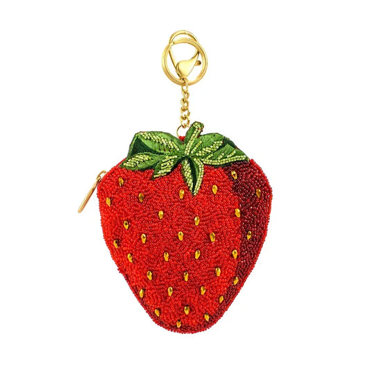 Red beaded strawberry coin purse with gold chain on a white background.
