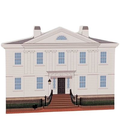 A wooden miniature replica of the Cotting-Smith Assembly House, featuring a white facade with blue window trim and historical details on the back.