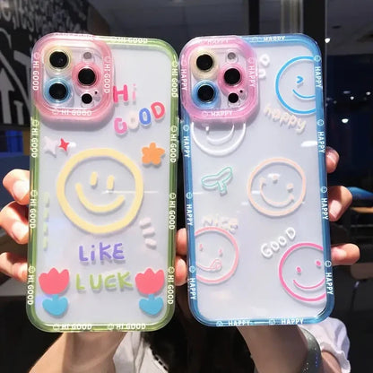 two people holding up their phone cases with smiley faces