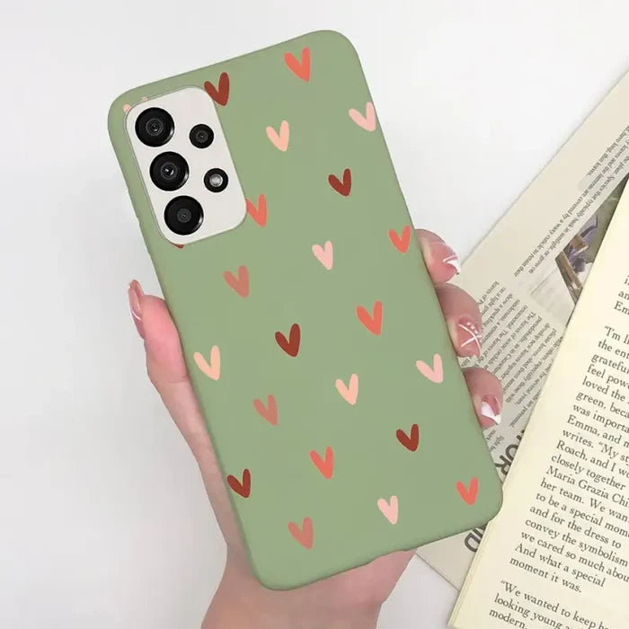 a woman holding a book and a phone case
