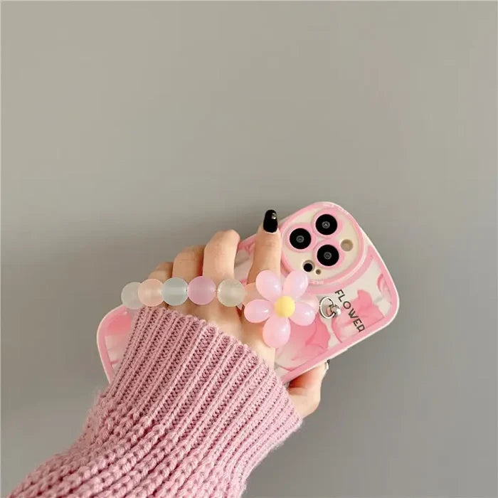 a person holding a pink phone case