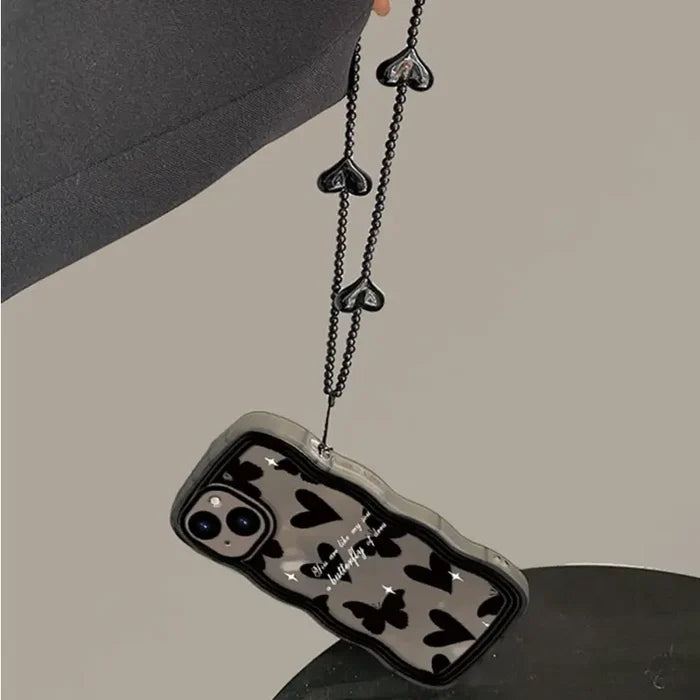 a black and white cell phone case with a chain