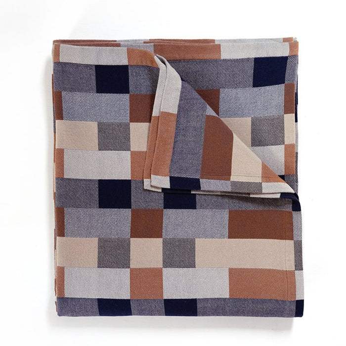 Blanket in a checkerboard pattern of grey, tan and brown.