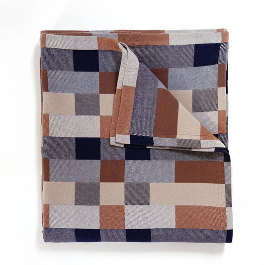 Blanket in a checkerboard pattern of grey, tan and brown.