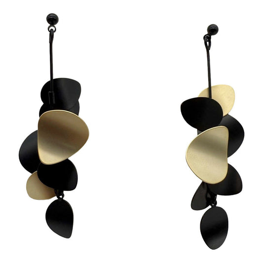 Pair of black and gold earrings on a white background