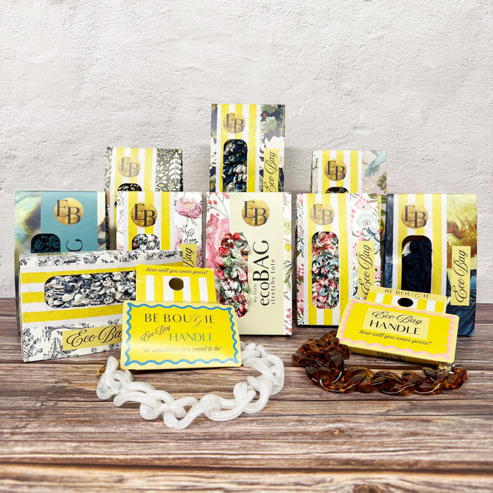Collection of eco-friendly product packaging on a wooden surface with a light gray background