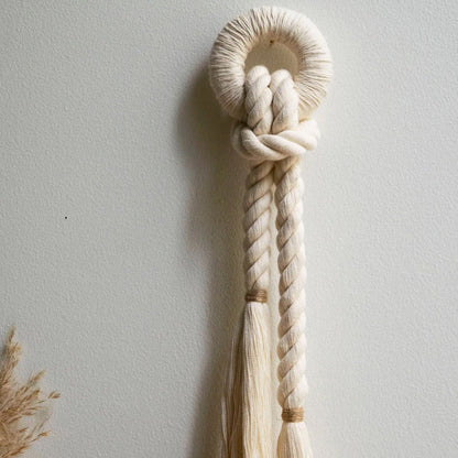 Handcrafted wall decor featuring natural cotton fiber rope with a color accent of jute.