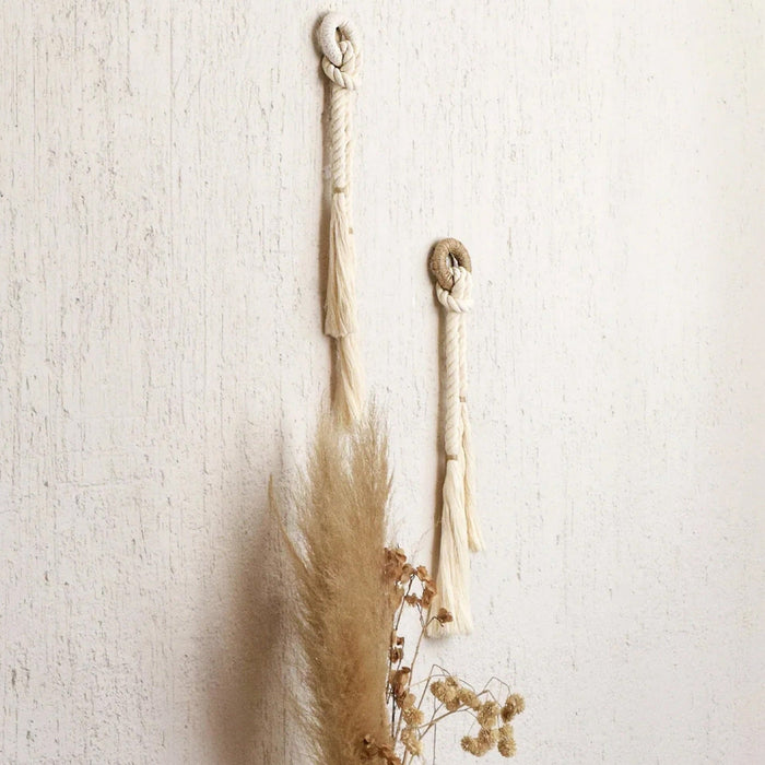 Handcrafted wall decor featuring natural cotton fiber rope with a color accent of jute,
