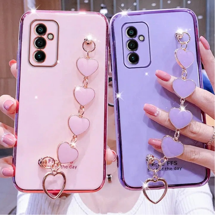 Pink and purple phone cases with heart charms.