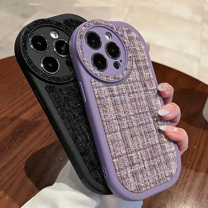 a woman holding a purple case with a black and white pattern