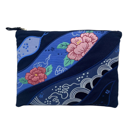 A navy-colored cotton pouch with floral and wave embroidery designs and a snake motif