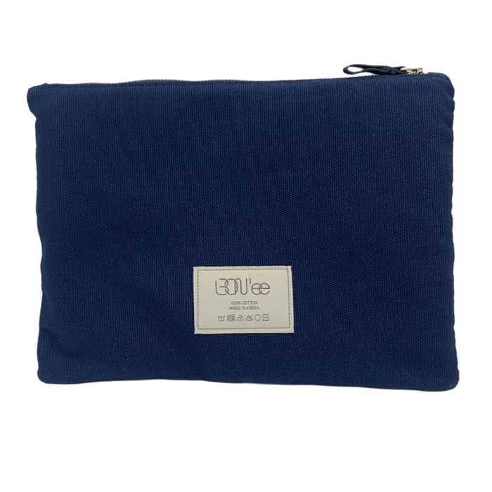 Navy blue back of a zippered pouch with maker's tag.