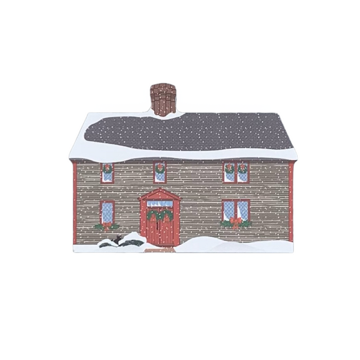A decorative block featuring the Samuel Pickman House, depicted with a snowy roof and a red front door, against a white background.