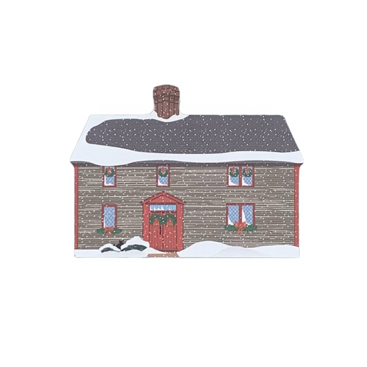 A decorative block featuring the Samuel Pickman House, depicted with a snowy roof and a red front door, against a white background.