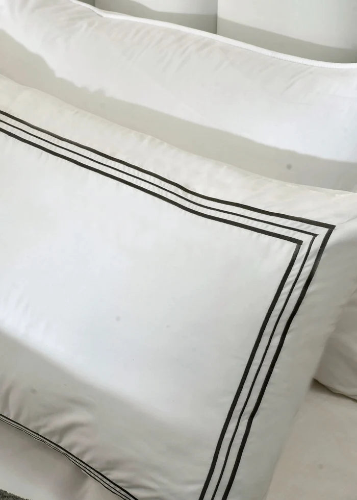 White duvet cover with black double-stripe border on pillow