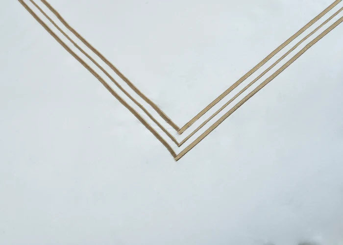 White pillowcase corner with gold double-stripe V border trim