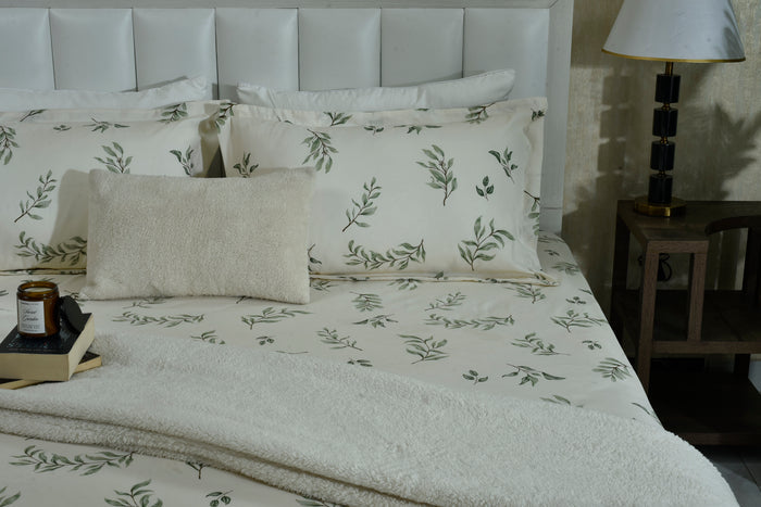 Cotton sateen flat sheet and pillowcases with scattered green leaf print