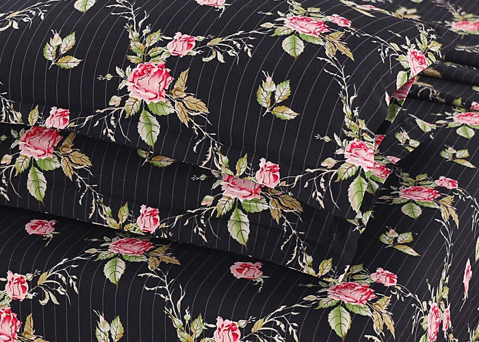 Black cotton pillow cover corner close-up with rose floral print on pinstripes
