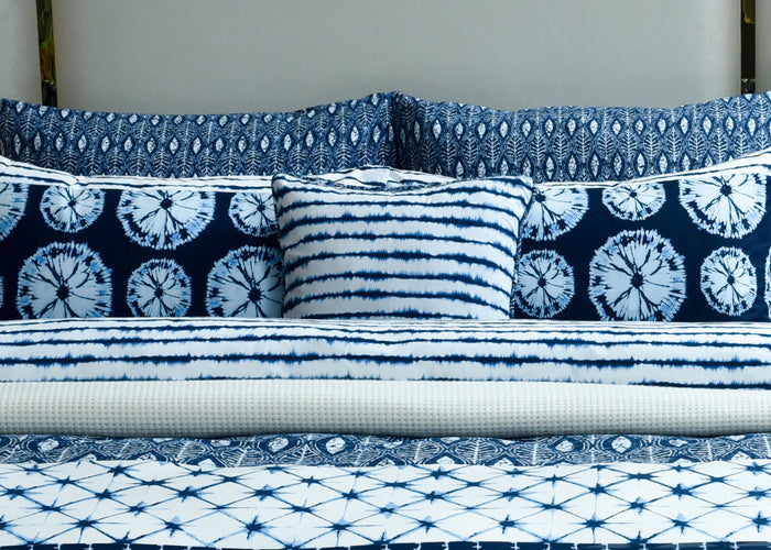 Blue and white patterned cushion cover set with striped and batik-style designs