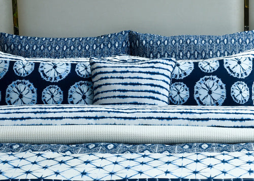 Blue and white patterned cushion cover set with striped and batik-style designs
