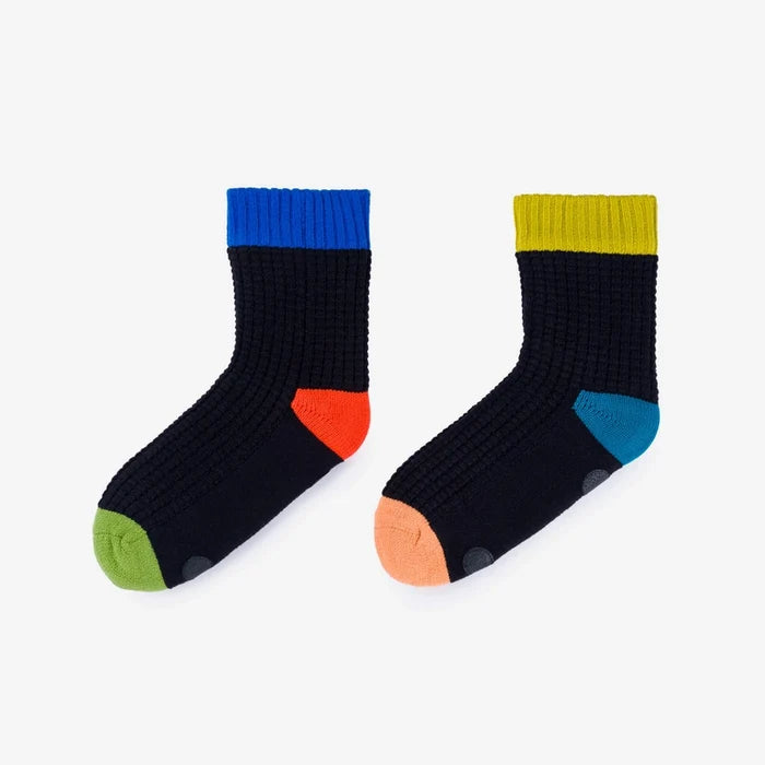 Pair of black socks with colorful accents on a light gray background