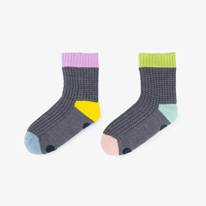 Pair of grey socks with colorful accents on a white background