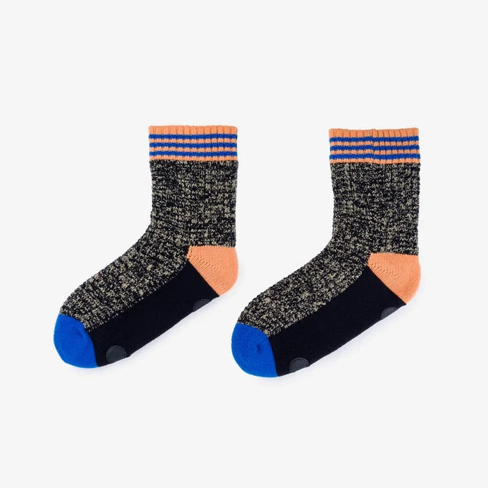 Pair of socks with black and gray speckled pattern, orange accents, and blue toes on a white background