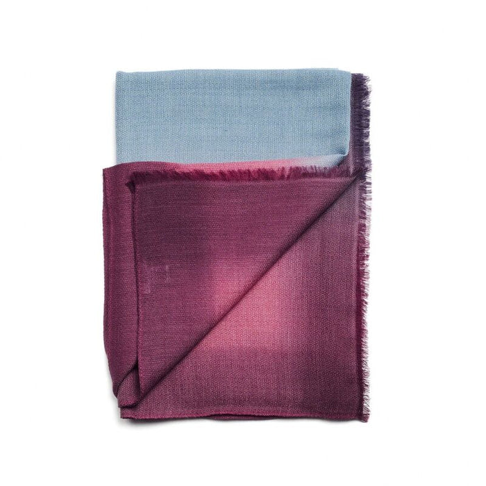 Folded fabric with blue and purple gradient on a white background