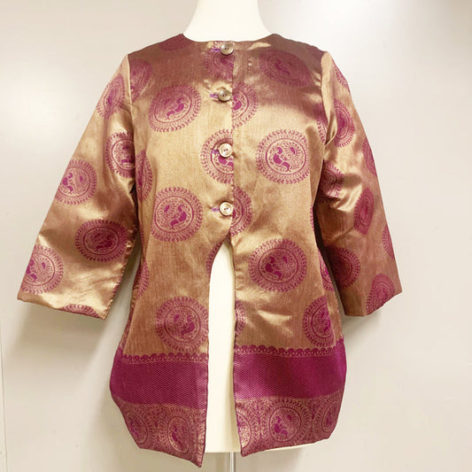 A 3/4 sleeve jacket with purple and gold colors, made from upcycled sari fabric, displayed on a mannequin.
