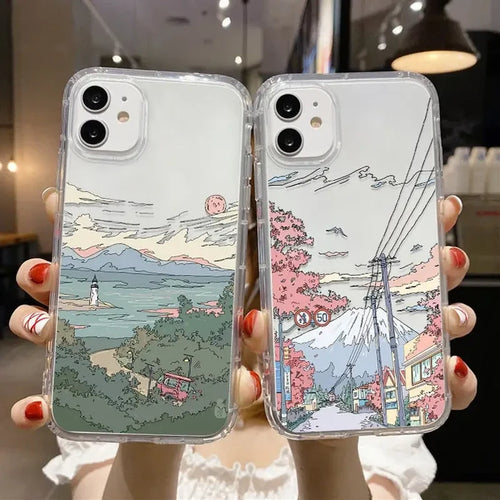 A woman holding up two cases with a drawing of a landscape